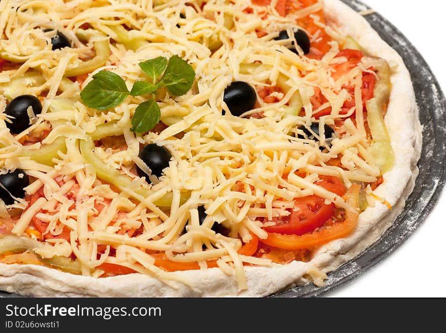 Uncooked vegetarian pizza isolated on white background