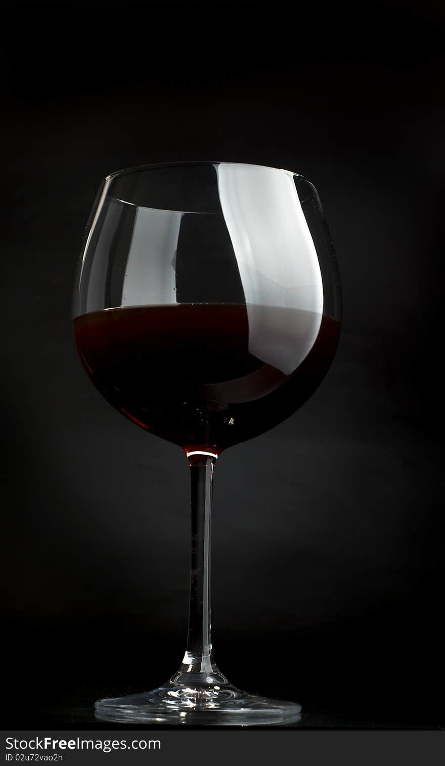 Glass of red wine on a dark background