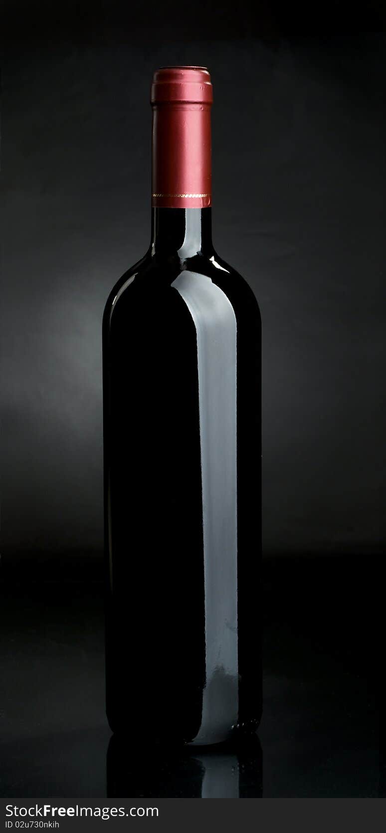 Bottle of red wine on a dark background