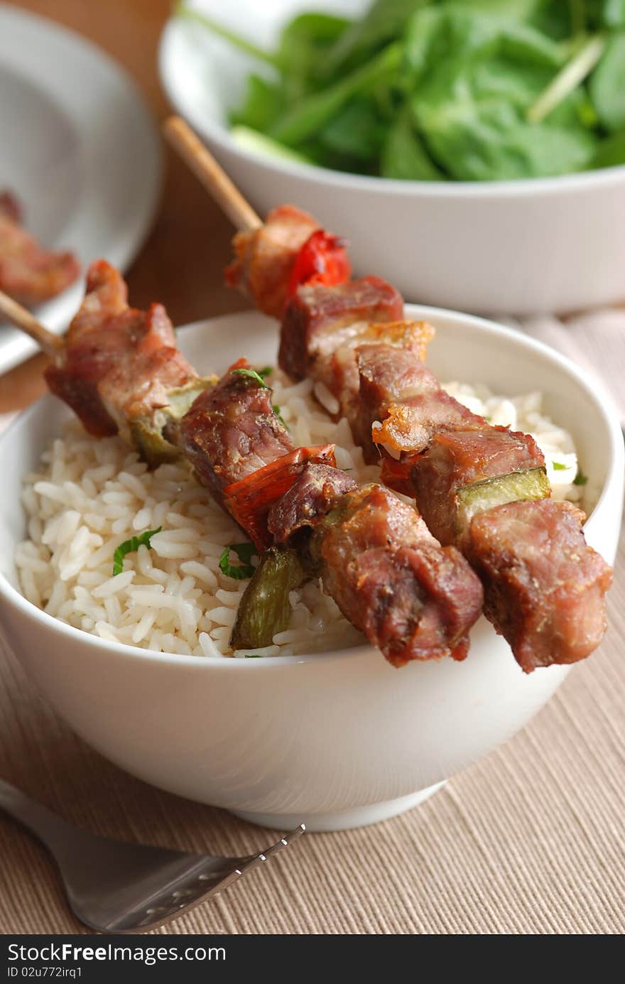 Pork skewers with rice in a bowl