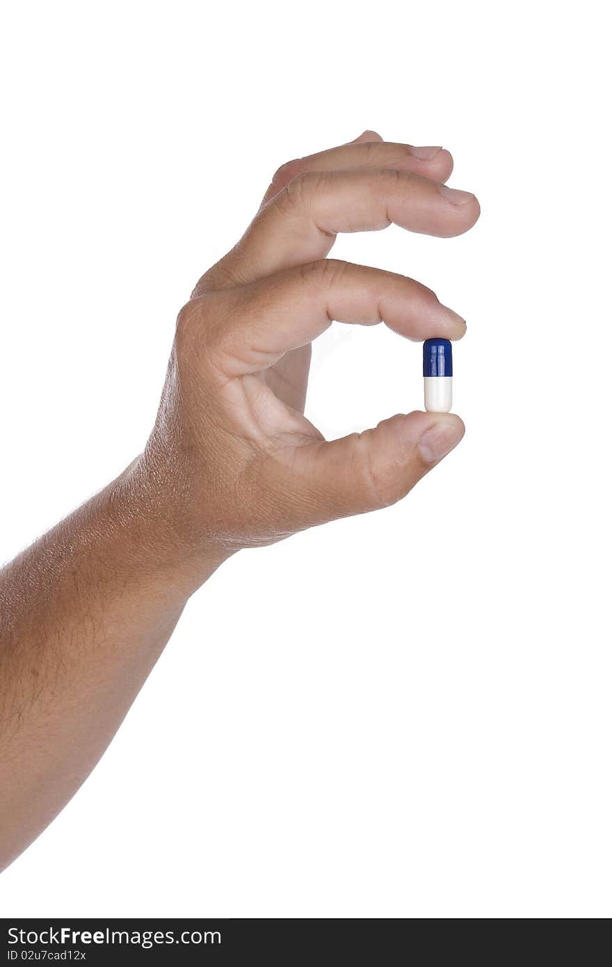 Hand is holding a pill isolated on white background