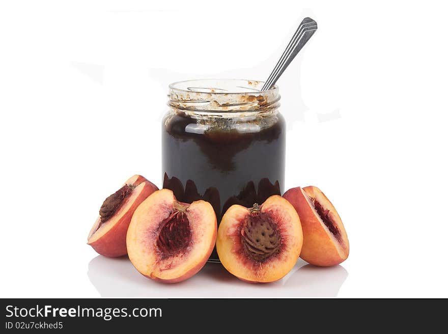 Peach jam glass jar and some fresh fruits isolated on white background