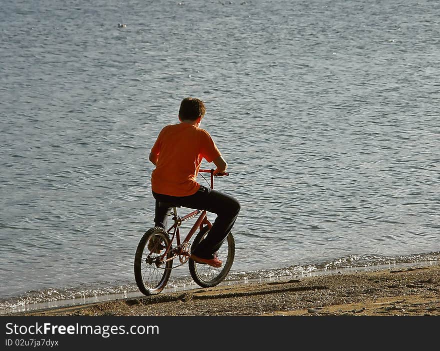 Boy riding a bicycle on a beach