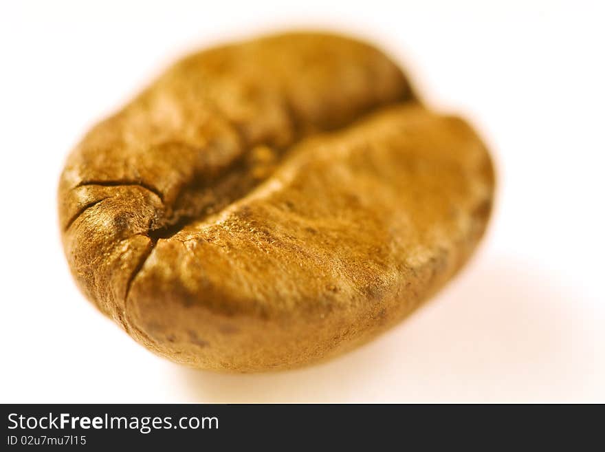 Macro of a brown good smelling coffeebean on white ground. Macro of a brown good smelling coffeebean on white ground