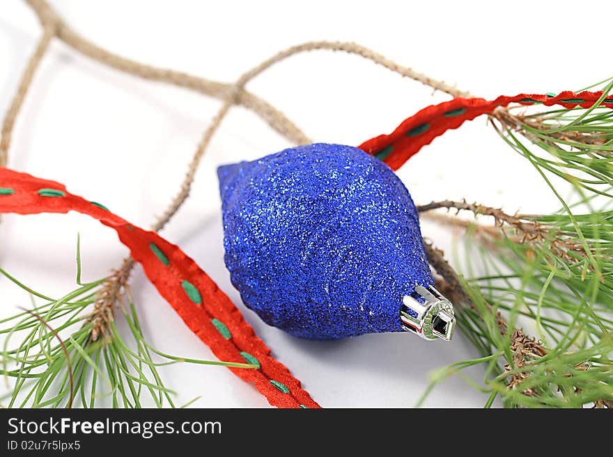 A blue ornament with tree branch.