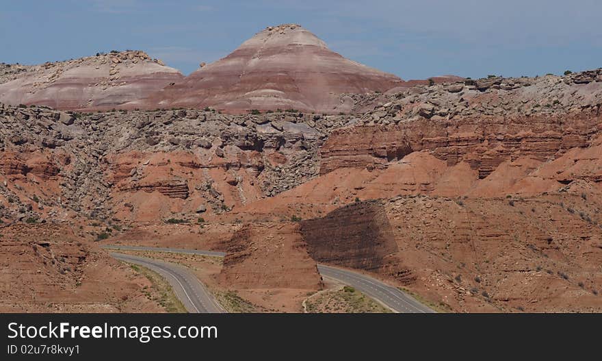 A four lane highway traveling through desert mountains. A four lane highway traveling through desert mountains.