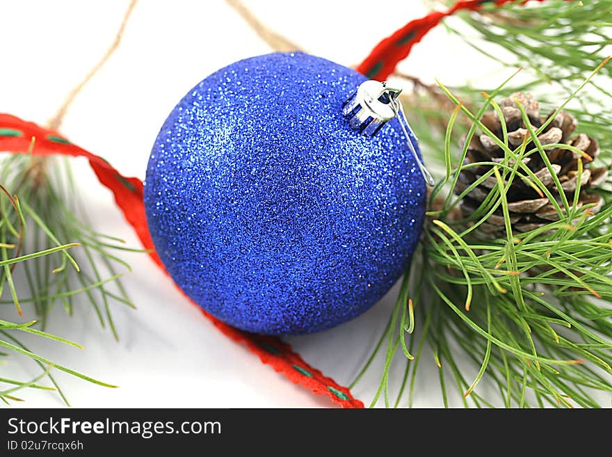 A blue ornament with tree branch.