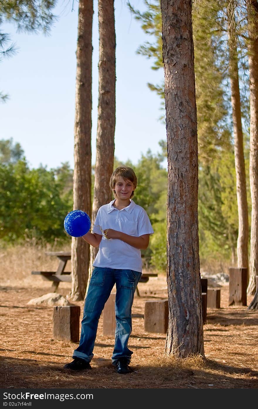 A boy with a balloon  on the background of nature. A boy with a balloon  on the background of nature.