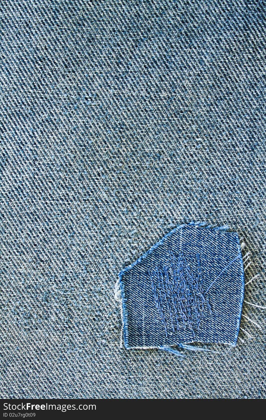 Fragment of blue modern jeans with patch, can be used as a background