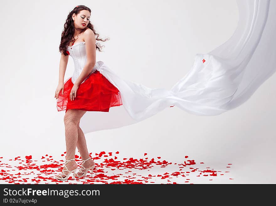 Young Beautiful Woman With Petals Of Roses