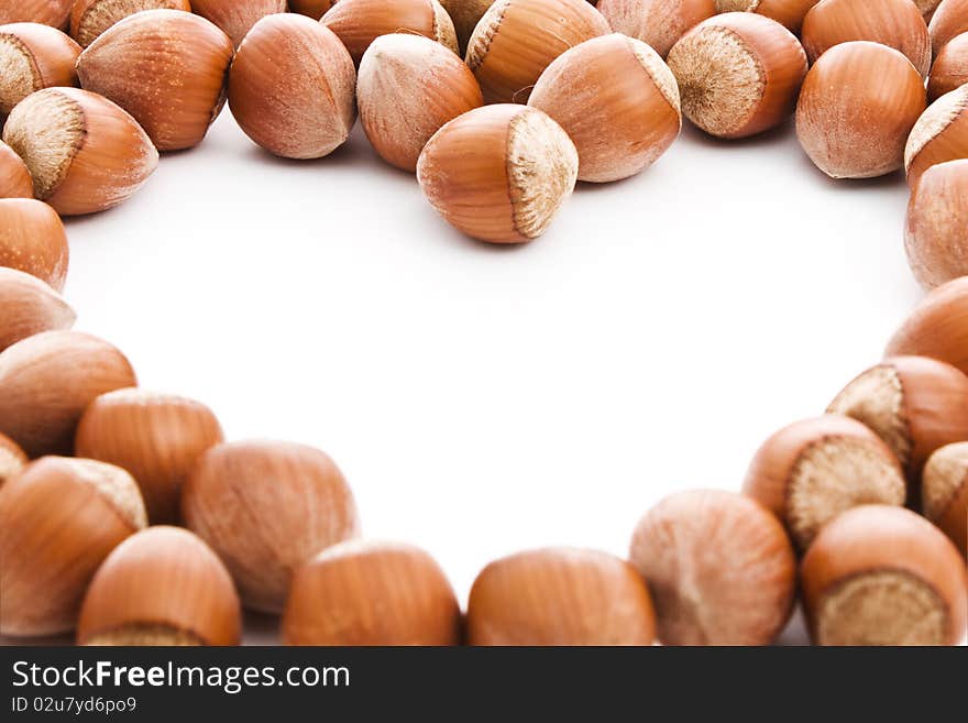 Hazelnuts with a free space in form of heart to place your information