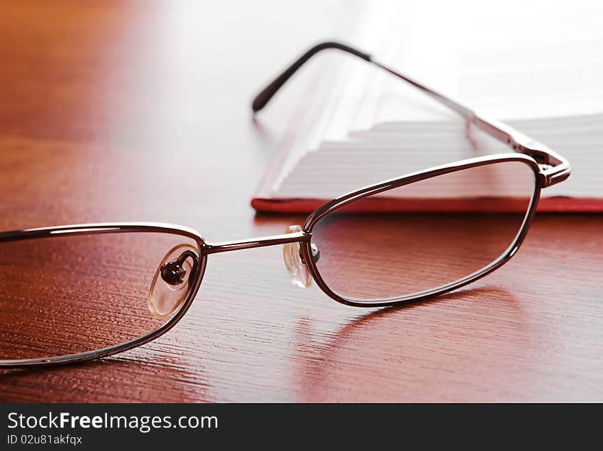 Glasses close up and the open book on a background. Glasses close up and the open book on a background