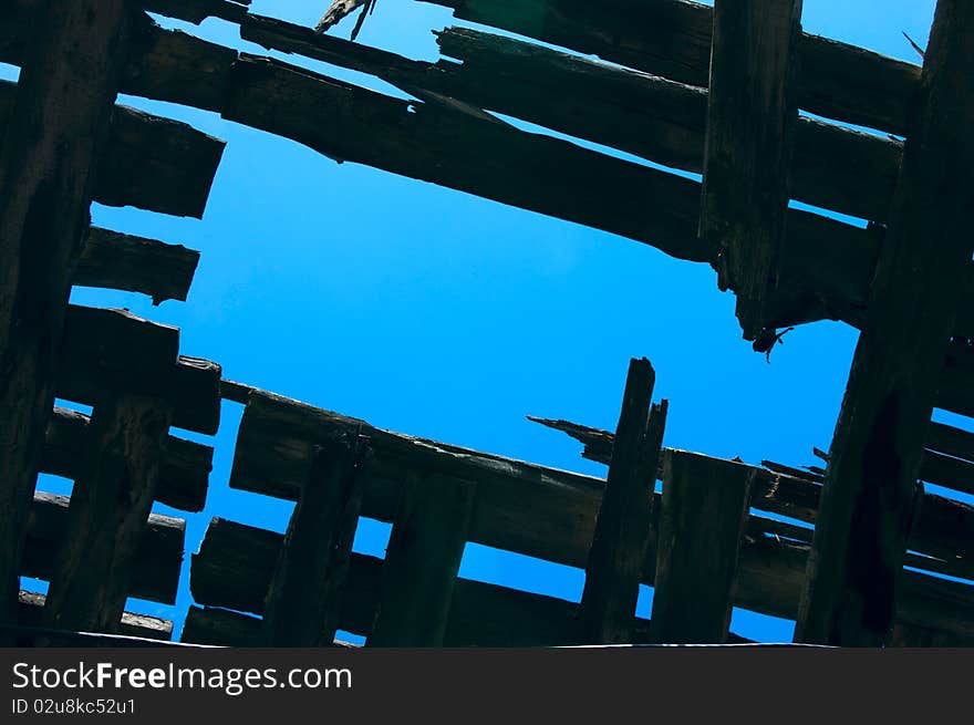 Blue sky hole in a old wooden roof. Blue sky hole in a old wooden roof