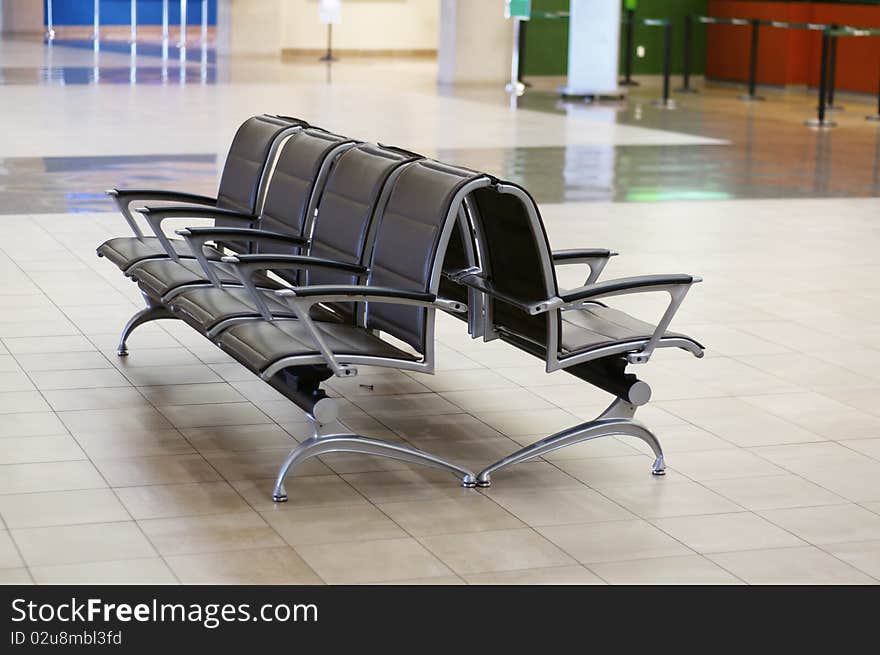 Empty Chairs in waiting area of airport