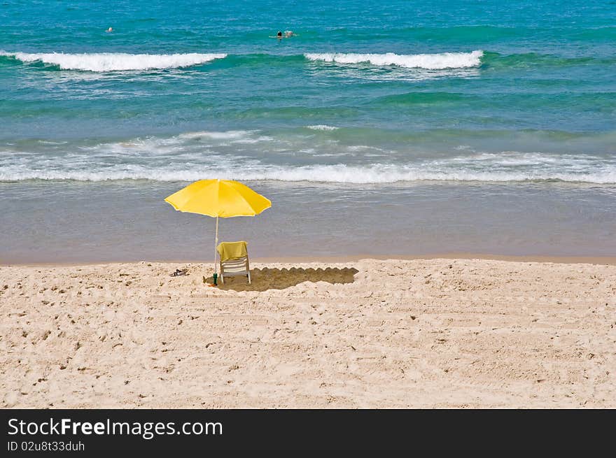 View of  chair and umbrella on the beach .