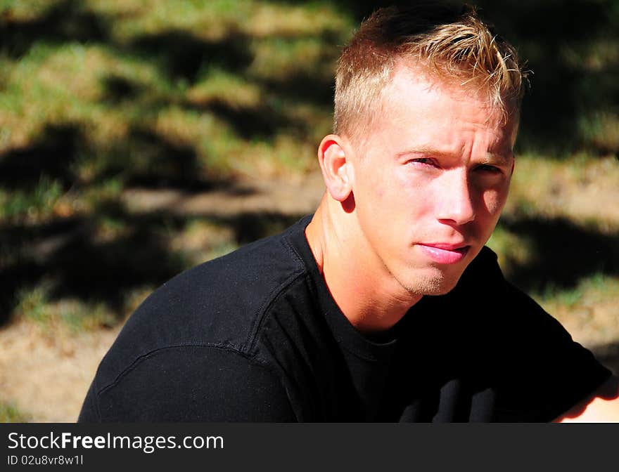 An adult male with a serious look on his face .