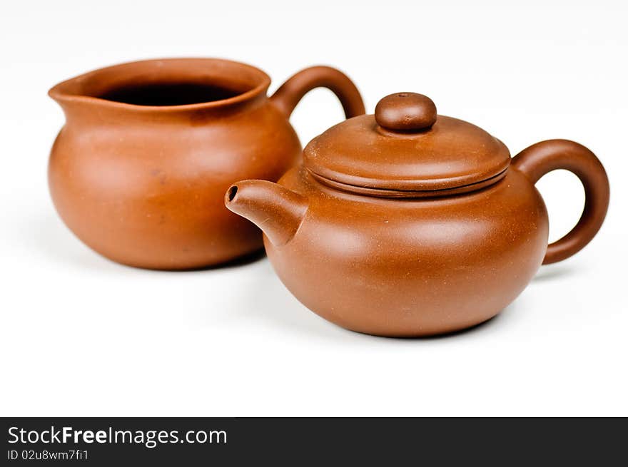 Brown clay tea pots on a white background