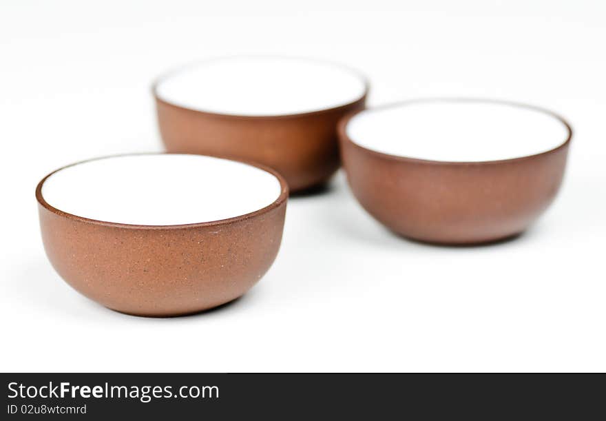 Three clay tea cups on a white background