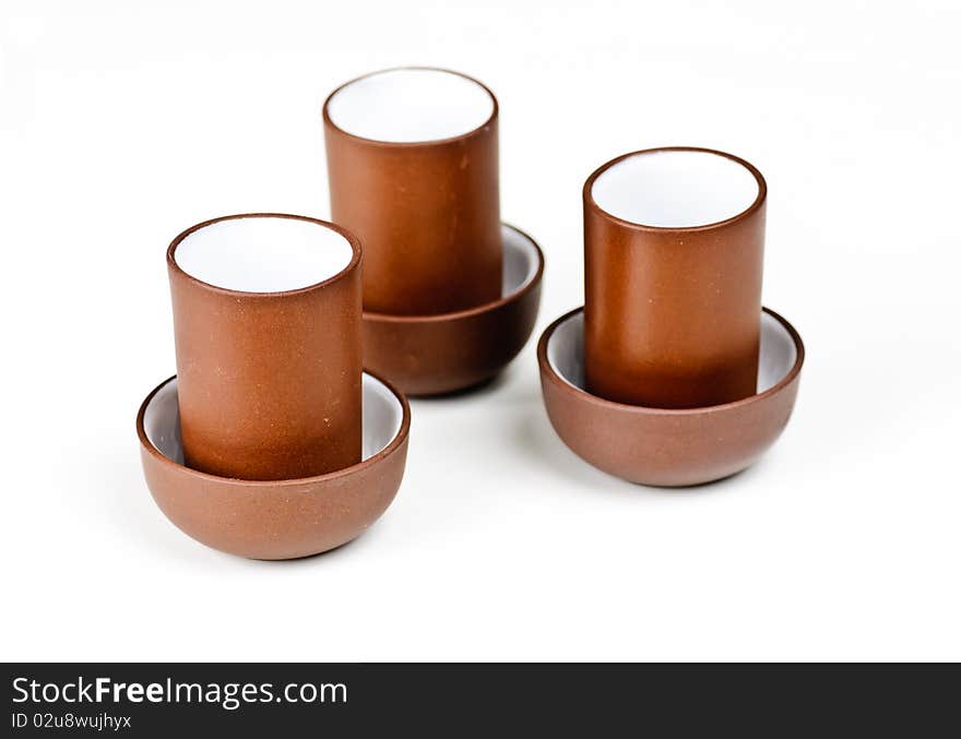 Three clay tea cups on a white background