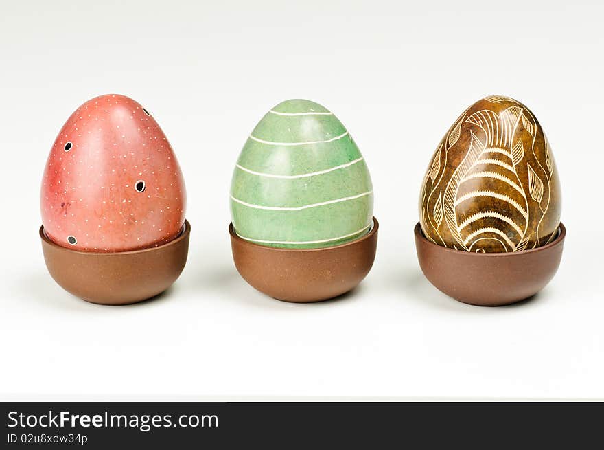 Three stone eggs on a white background