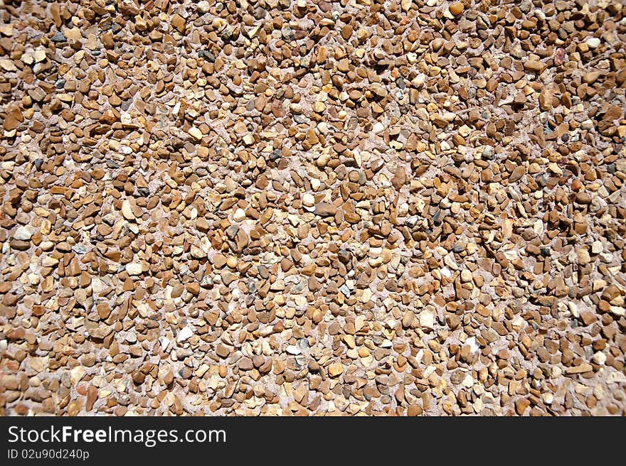 Small gravel sunlit texture background. Small gravel sunlit texture background