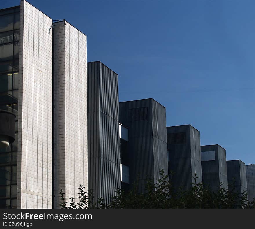 Line of high buildings on a clear blue sky