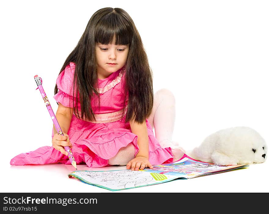 Little girl with pencil lying on floor. isolated