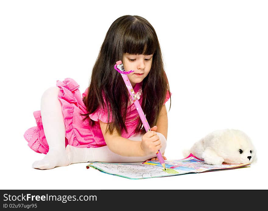 Little girl with pencil lying on floor. isolated