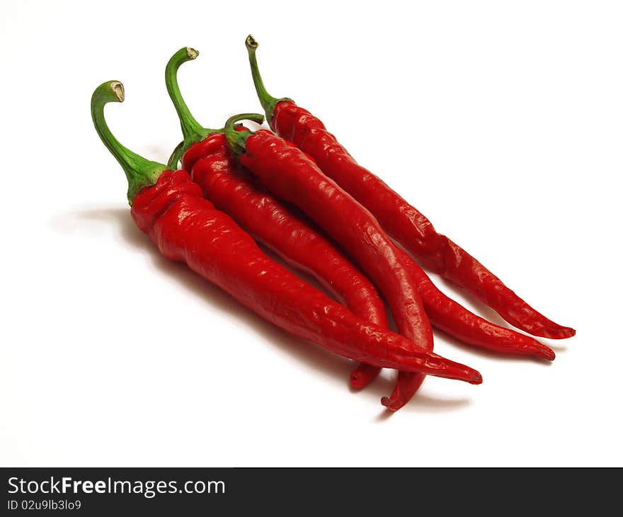 Red chili peppers isolated against a white background. Red chili peppers isolated against a white background