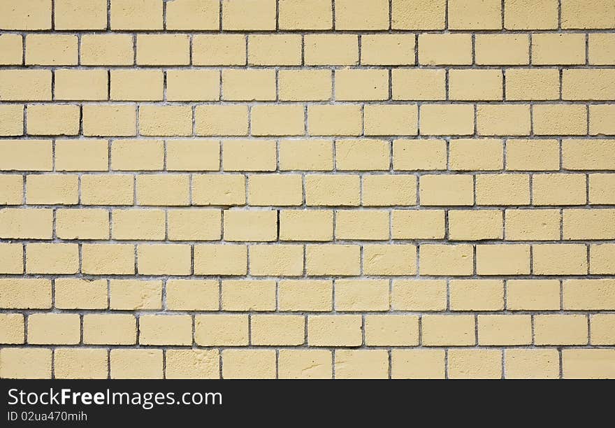 Yellow weathered brick wall background. Close up. Yellow weathered brick wall background. Close up