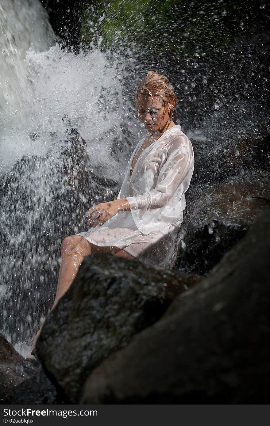 Young Woman Near The Waterfall