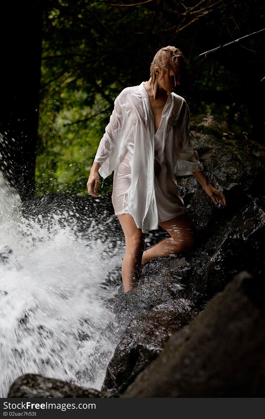 Young Woman Near The Waterfall