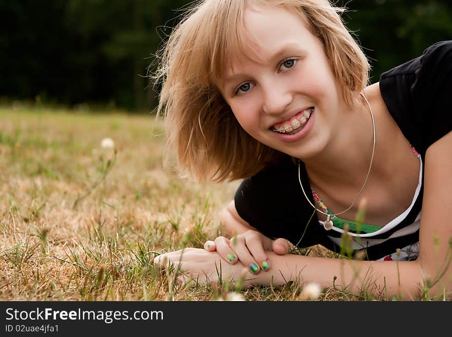 Young summer girl portrait in the grass. Young summer girl portrait in the grass