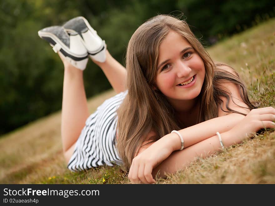 Young summer girl portrait in the grass. Young summer girl portrait in the grass