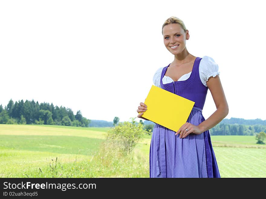 Beautiful bavarian Girl holding a yellow plate