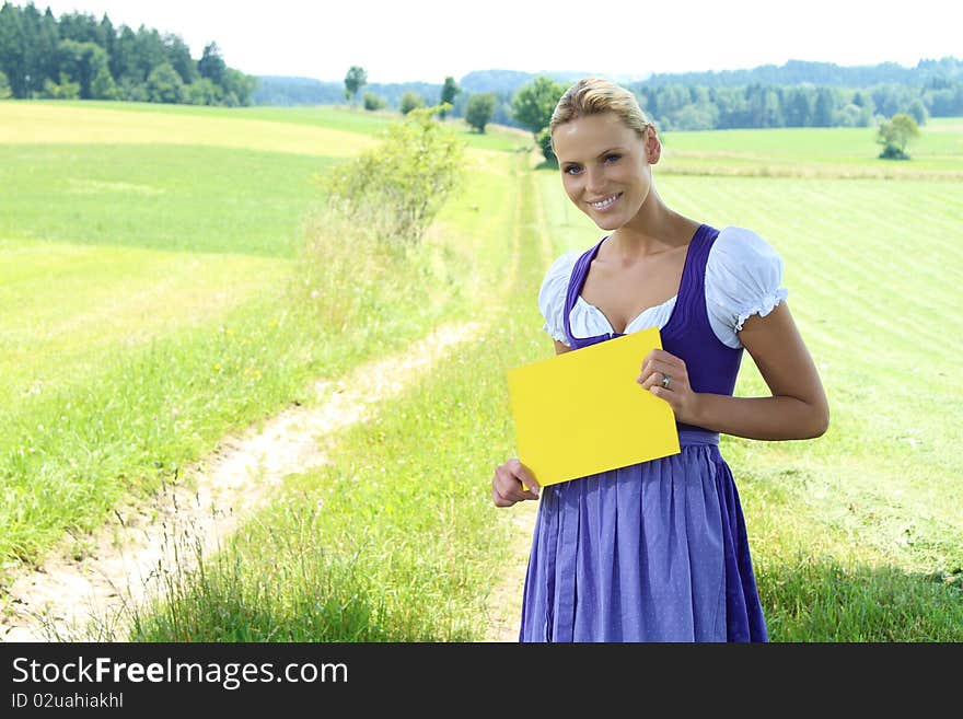 Beautiful bavarian Girl holding a yellow plate