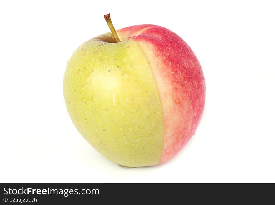 Half red and half green apple with water drops isolated on white background.