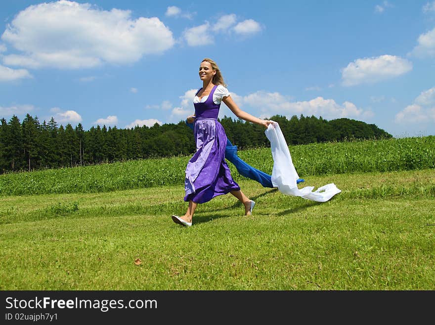 Beautiful bavarian Woman running with Cloths