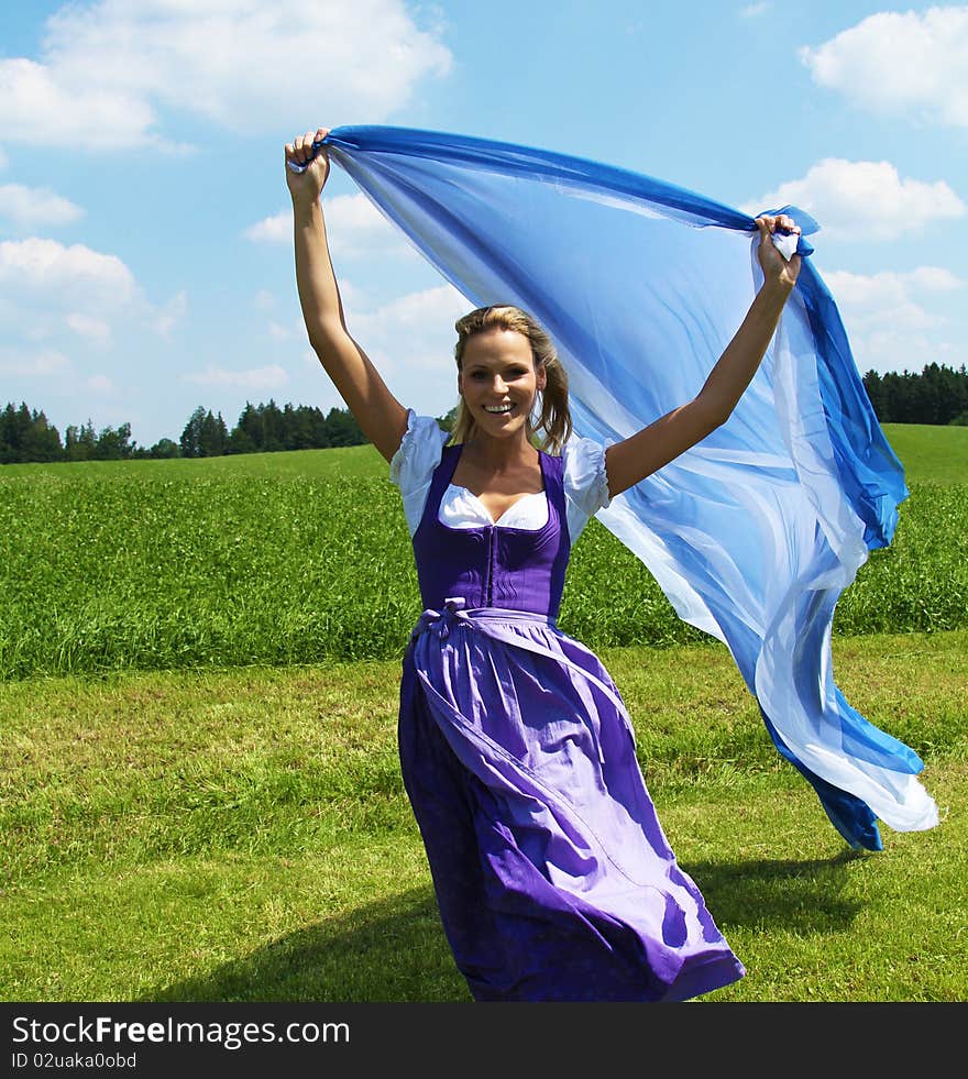 Beautiful bavarian Woman running with Cloths