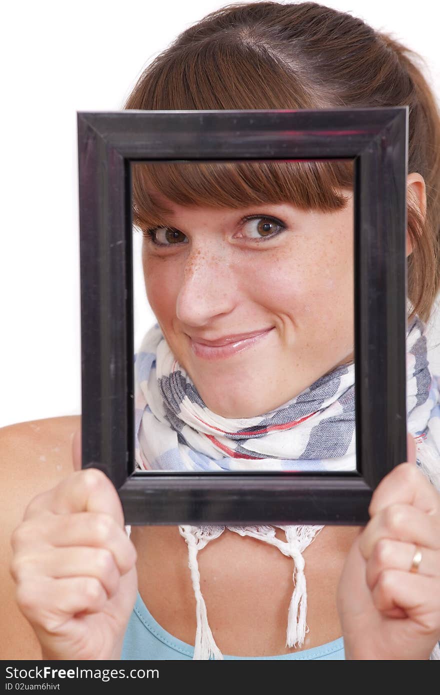 Happy woman looking through photo frame over white background. Happy woman looking through photo frame over white background