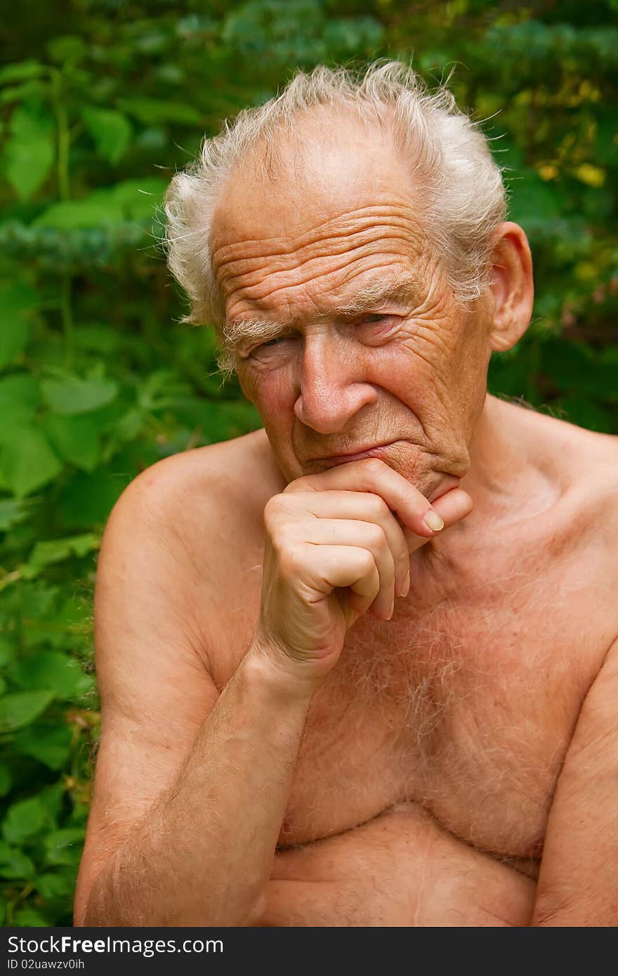 Close-up portrait of a pensive senior man holding his hand near his face. Close-up portrait of a pensive senior man holding his hand near his face