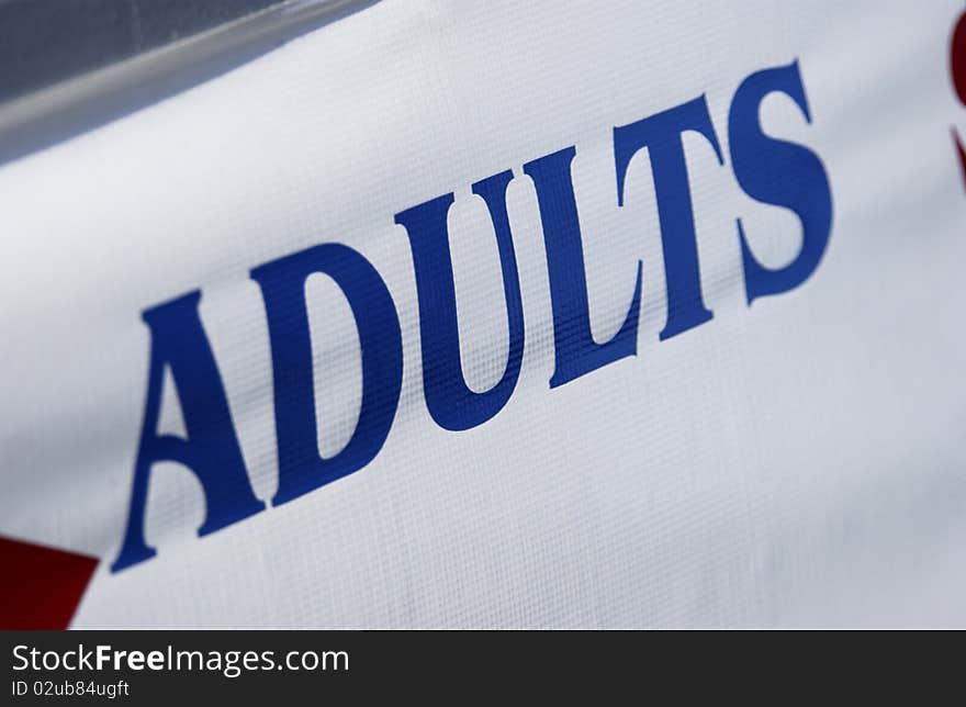 Adults sign on white banner. Adults sign on white banner