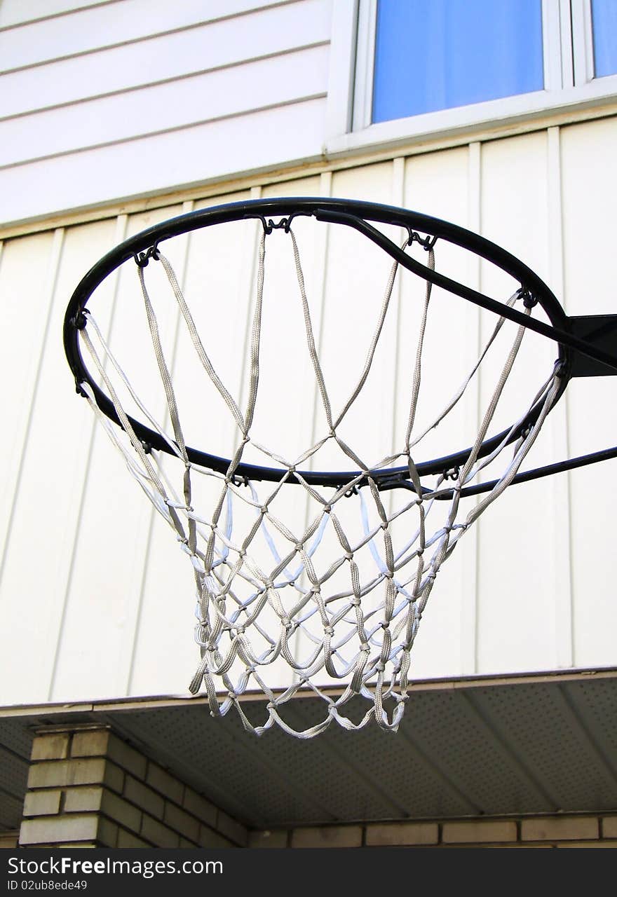 Basket next to white façade. Basket next to white façade