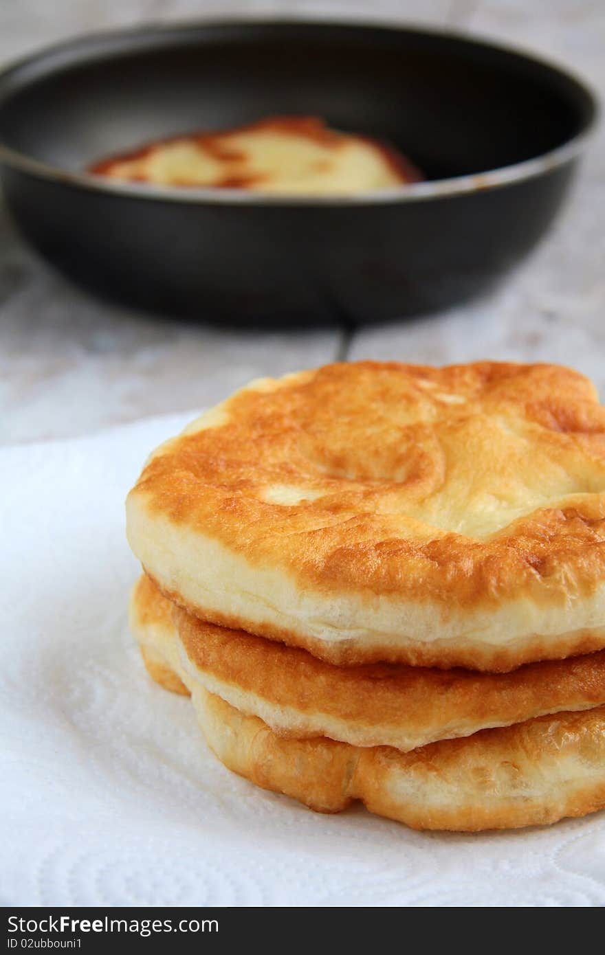 Bread fried in butter on a plate and pan