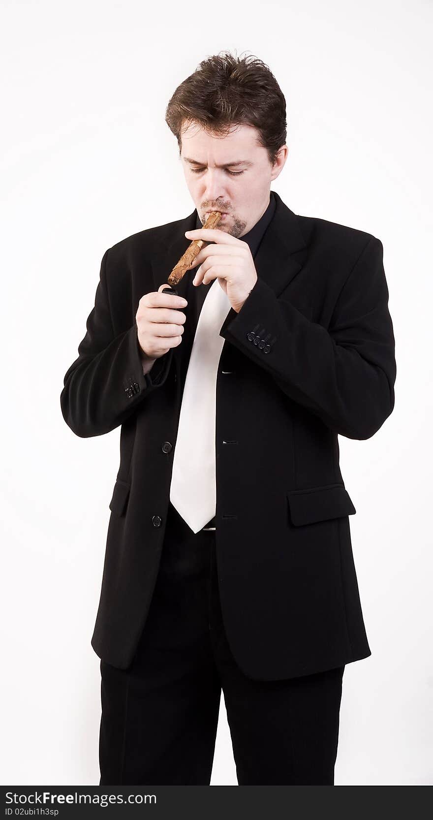 Business man in black suit smokes a cigar. Business man in black suit smokes a cigar