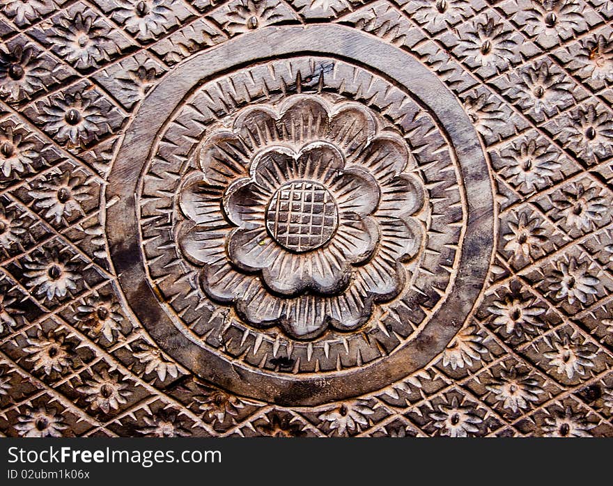 Texture of handmade wooden table that has a sunflower as a picture on it. Texture of handmade wooden table that has a sunflower as a picture on it