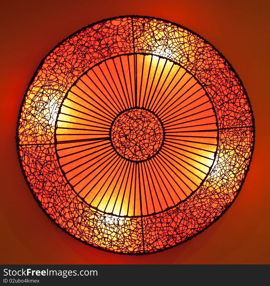 Circle rattan lamp with orange paper in restuarant. Circle rattan lamp with orange paper in restuarant