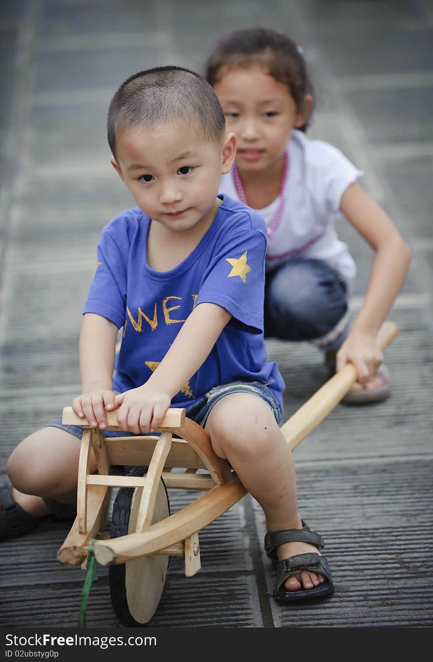 Sister and brother play wood trolley. Sister and brother play wood trolley.