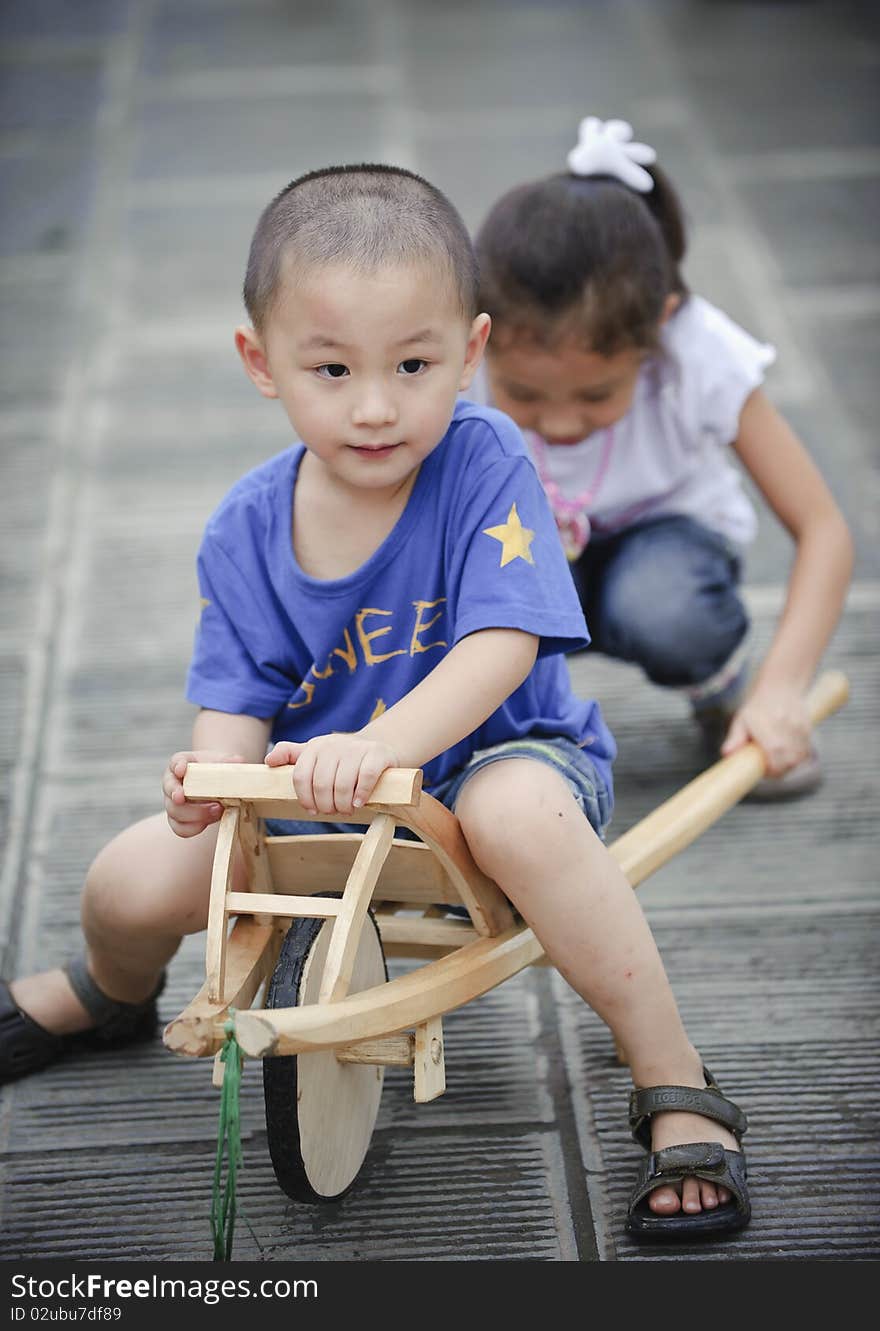 Sister and brother happy play wood trolley. Sister and brother happy play wood trolley.