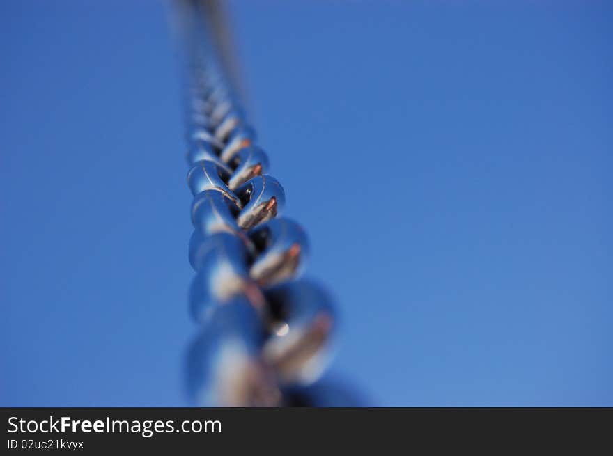 Metal chain against the blue sky. Metal chain against the blue sky